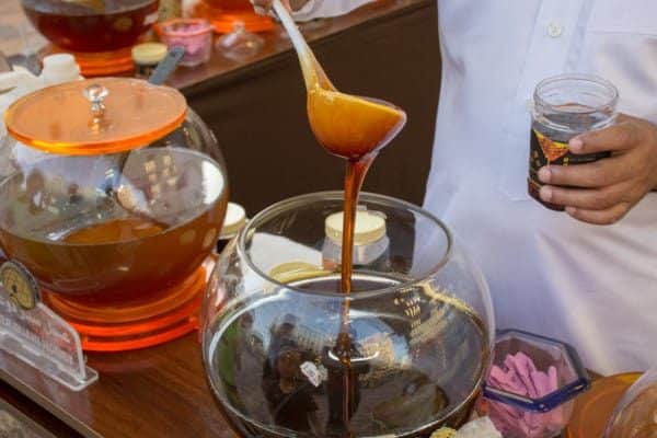 Sidr honey being poured from a ladle